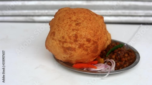 Plate of Indian chole bhature served with onions and chutney. 