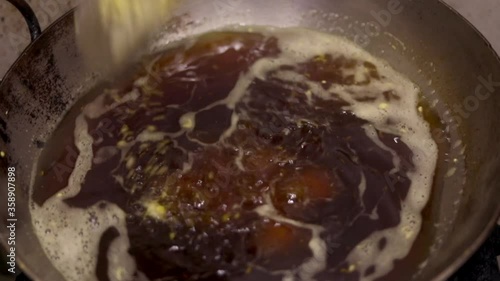 Making fried potato balls or indian vada in a kadhai filled with oil. Vada pav.
