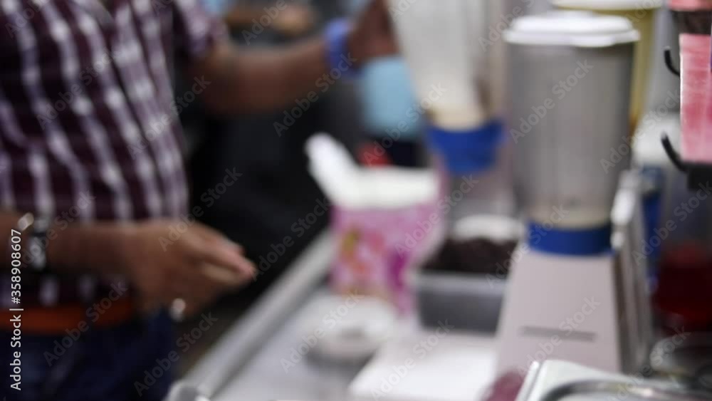 Making ice cream sundae shake dessert with cream, fruits and cherry toppings. Making ice cream sundae shake dessert with cream, fruits and cherry toppings.