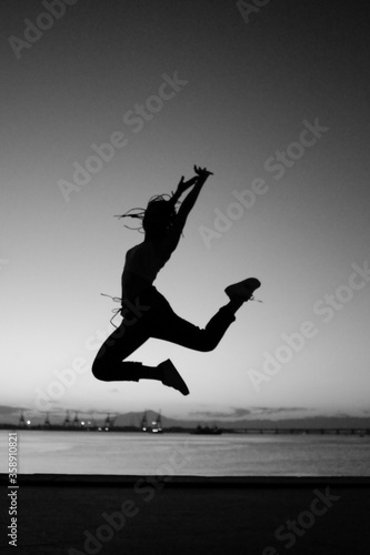 Girl jumping at a sunset 