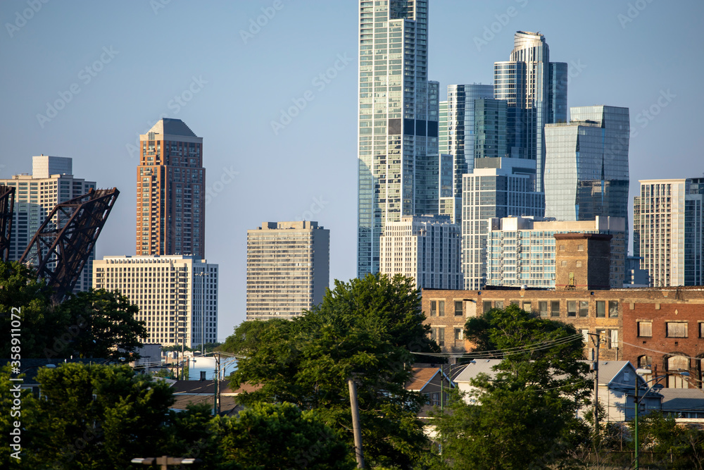 Chicago Skyline view of beautiful architecture of the city's wonderful downtown urban district.  The cityscape buildings have a warm glows from the sun setting golden hour