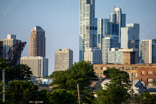 Chicago Skyline view of beautiful architecture of the city's wonderful downtown urban district.  The cityscape buildings have a warm glows from the sun setting golden hour © ezellhphotography