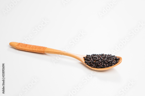 Black wild rice in a wooden spoon