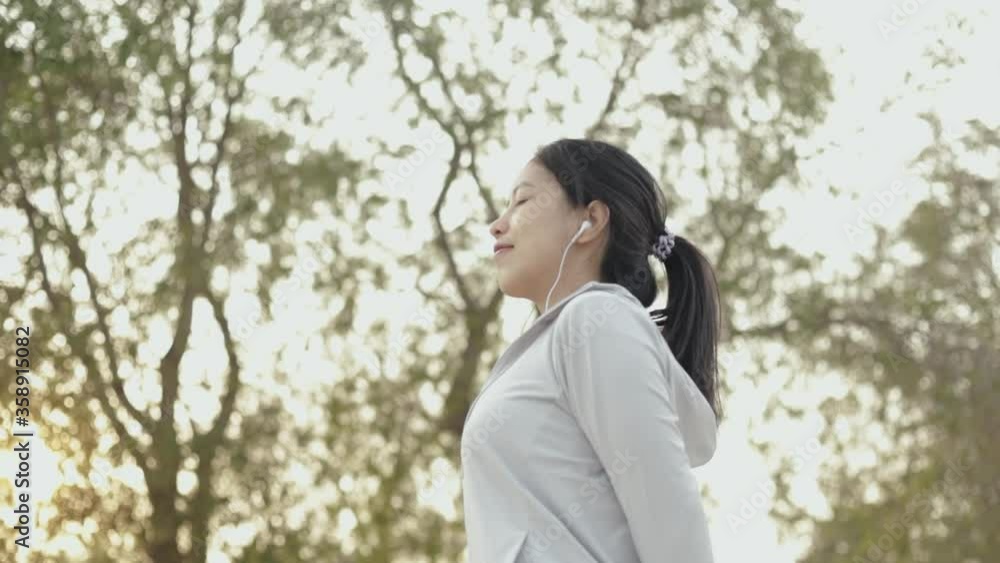 Attractive young asian female runner standing seaside relaxing on the beach after running, health lifestyle workout athletic. Attractive young asian female runner standing seaside relaxing on the beach after running, health lifestyle workout athletic.