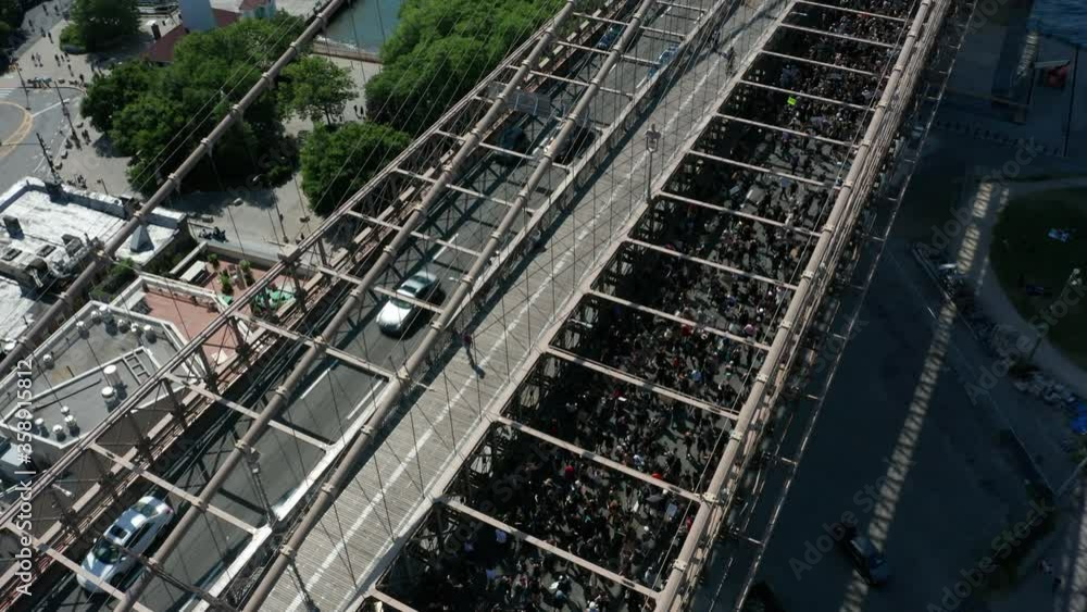 tilting up from Black Lives Matter march to reveal Brooklyn Bridge tilting up from Black Lives Matter march to reveal Brooklyn Bridge