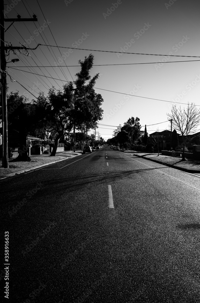 Black and white photo of a suburban road