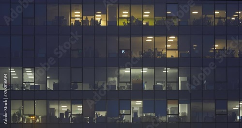 Timelapse people working late in corporate building at night