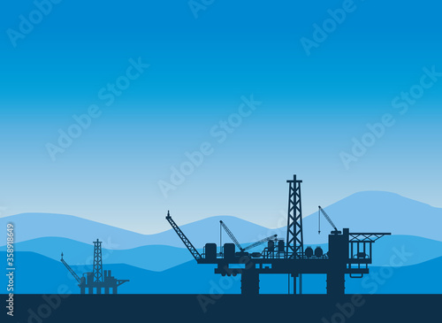Foto Vector illustration of two offshore oil rig silhouettes with blue mountains in the background