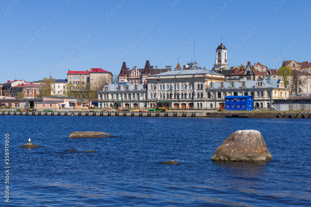 The old administrative building of the Vyborg port (1899) in the city landscape on a sunny May day. Vyborg, Russia