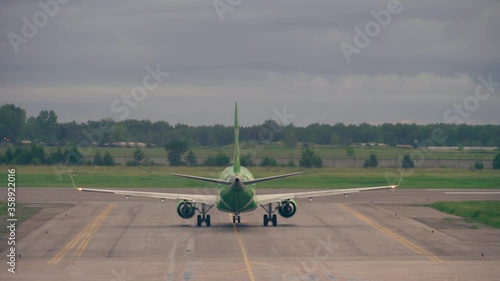 Plane turns on the runway at early morning photo