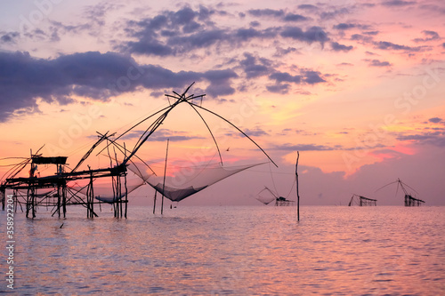 A giant dip net for scooping fish in morning Beautiful sunrise at pakpra phatthalung Southern region of Thailand, Beautiful landscape.