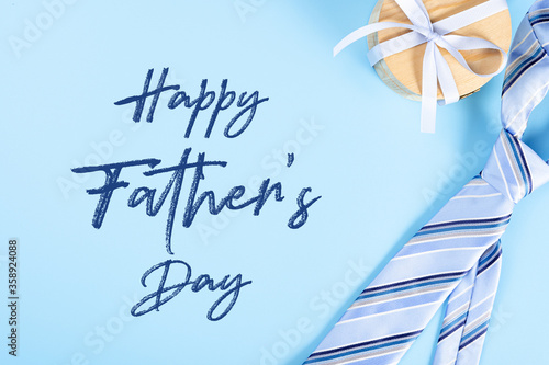 Happy Father Day background concept with blue necktie and gift box on blue background with copy space for text.