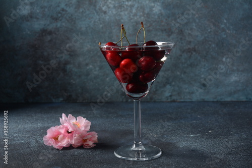 Sweet red and yellow cherries in a glass. Cherry close-up in a glass with water drops. Summer sweet dessert