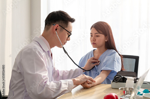 Female Patient Being Reassured by Doctor. Young patient visiting doctor in hospital. Smiling patient receiving a medical consultation and looking at camera. healthcare and assistance concept.