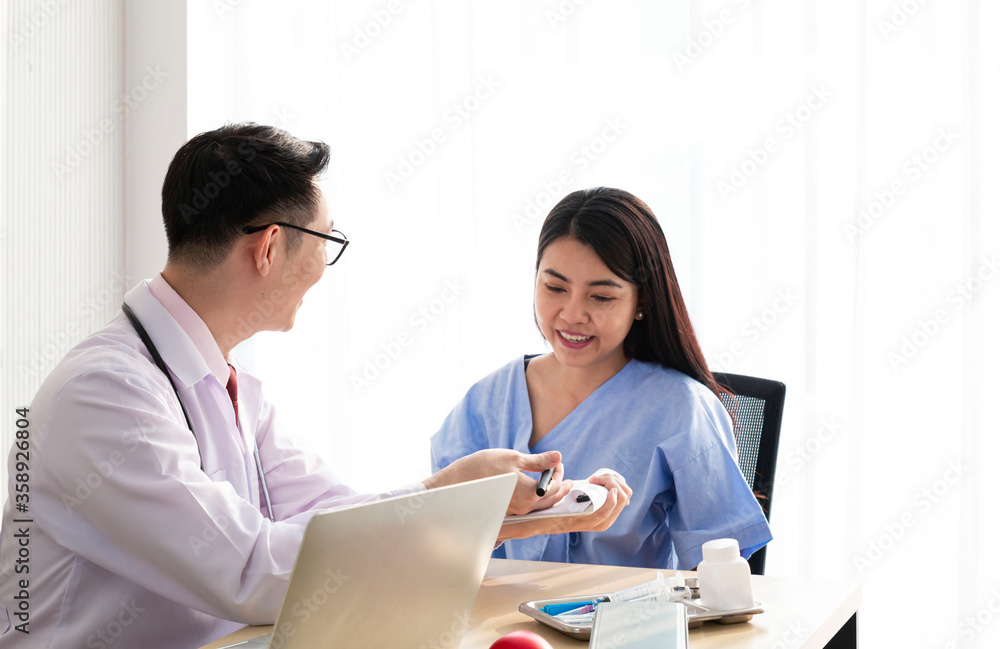 Doctor with female patient. Doctor and patient discussing something while sitting at the table, explaining diagnosis to his female patient. Medicine and healthcare concept. Coronavirus, Covid-19. Doctor with female patient. Doctor and patient discussing something while sitting at the table, explaining diagnosis to his female patient. Medicine and healthcare concept. Coronavirus, Covid-19.