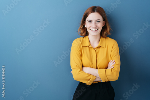 Pretty young woman with folded arms