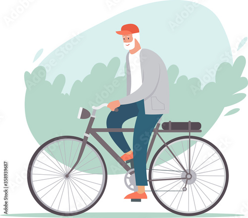 Elderly man riding a bicycle in the park. Active retirement concept.