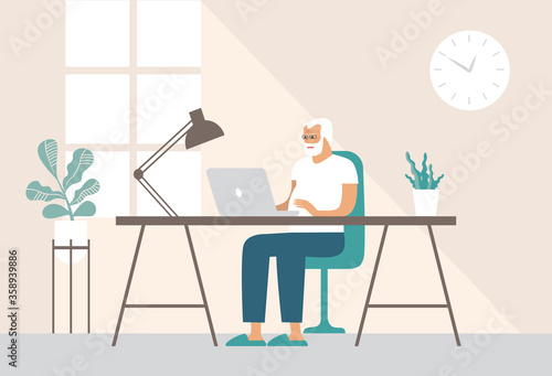 Old man working with his laptop at home. Browsing the internet. Online Shopping, working from home, communicating on social media