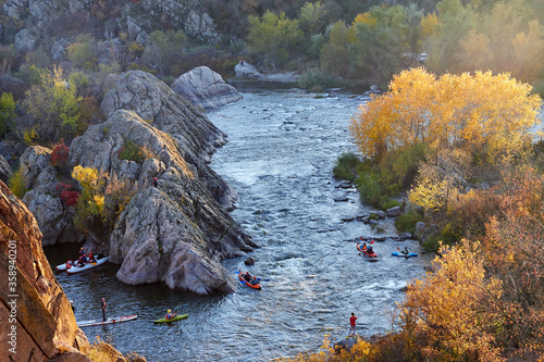 Bilde på lerret Landscape view from above on whitewater kayakers in Southern Bug river at autumn