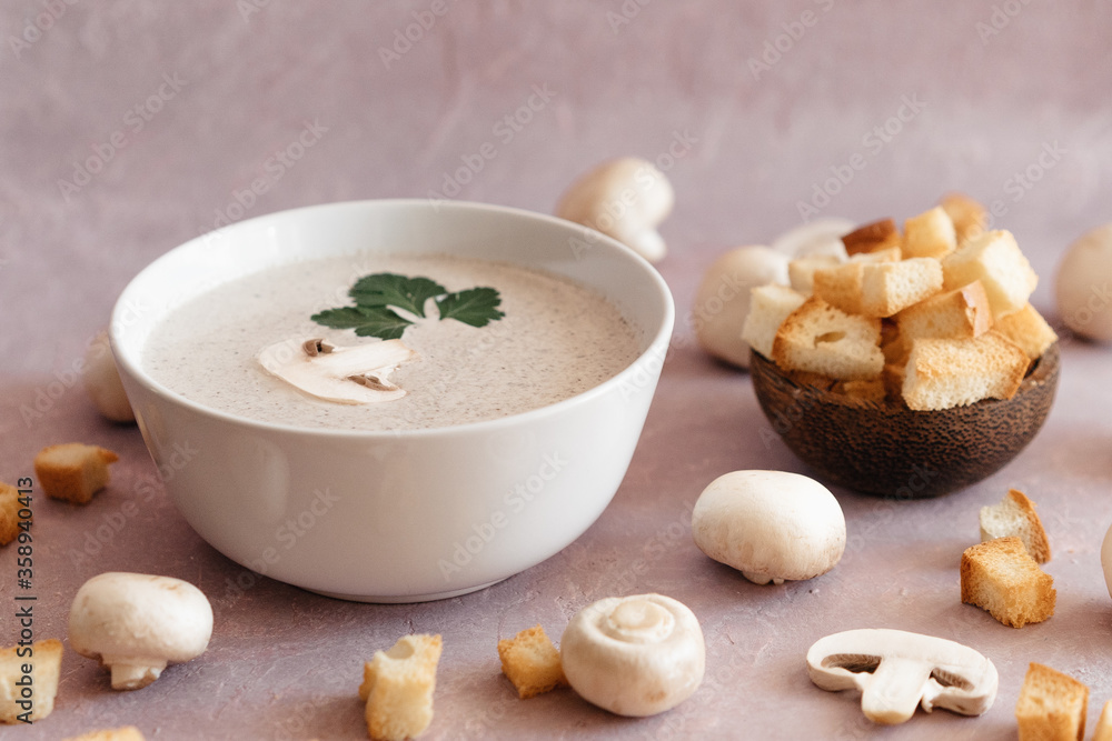 creamy mushroom cream soup with champignons serving in delicate pink colors creamy mushroom cream soup with champignons serving in delicate pink colors