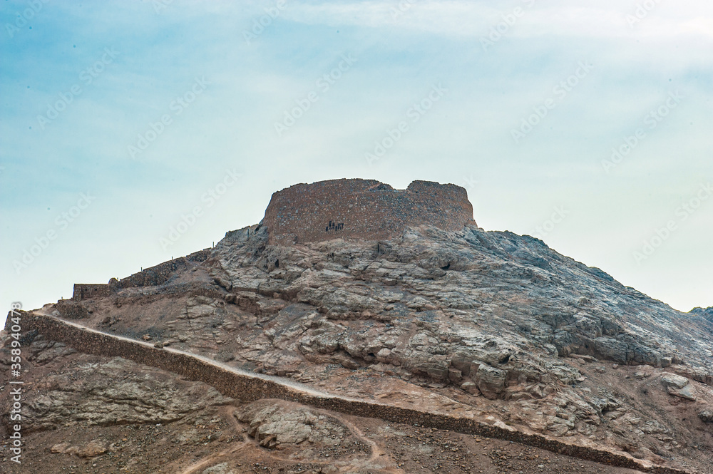 It's Tower of Silence, Iranian Zoroastrian tradition, the towers were built atop hills or low mountains