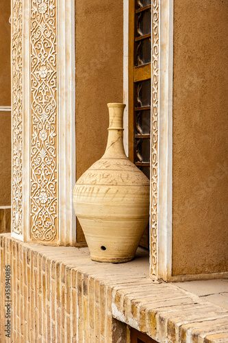 It's Clay jar near the window photo