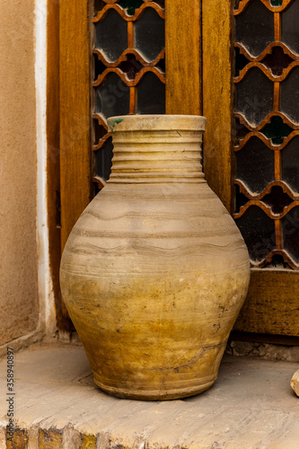 It's Clay jar near the window photo