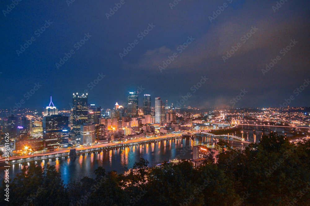 Panorama view of City Pittsburg Skyline along the Ohio River at night