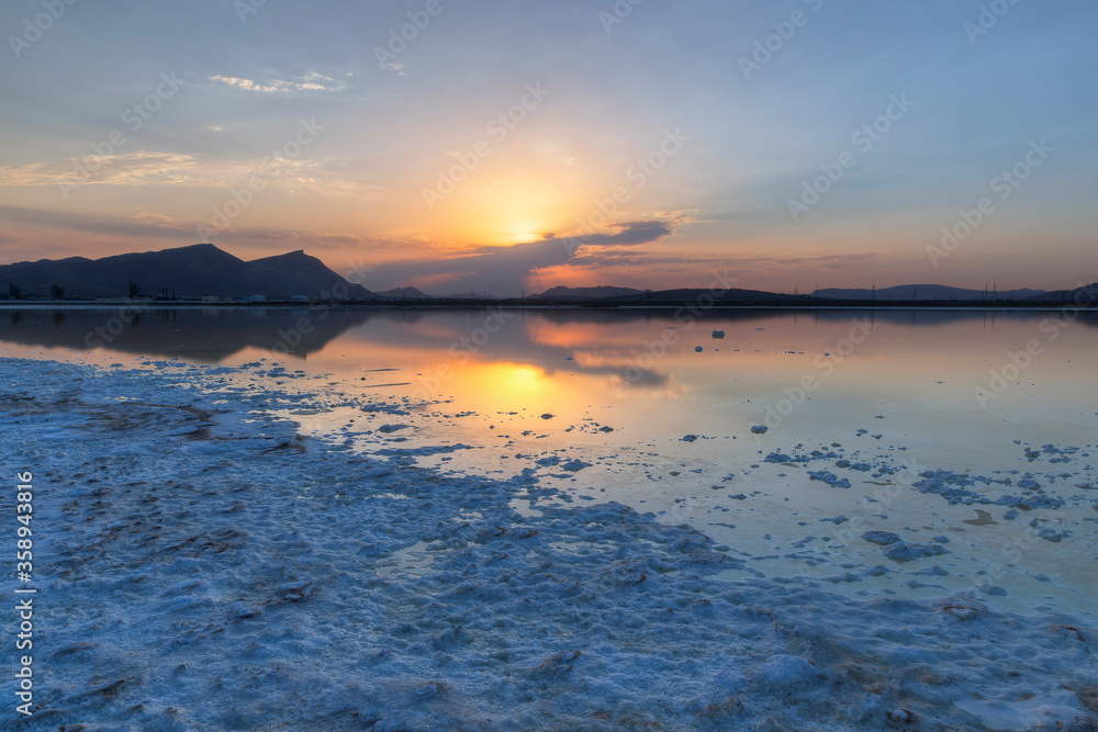 Salt lake shore at sunset day