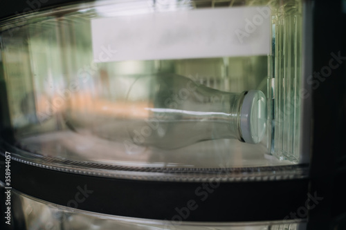 reusable milk bottles for milk delivery in a machine photo