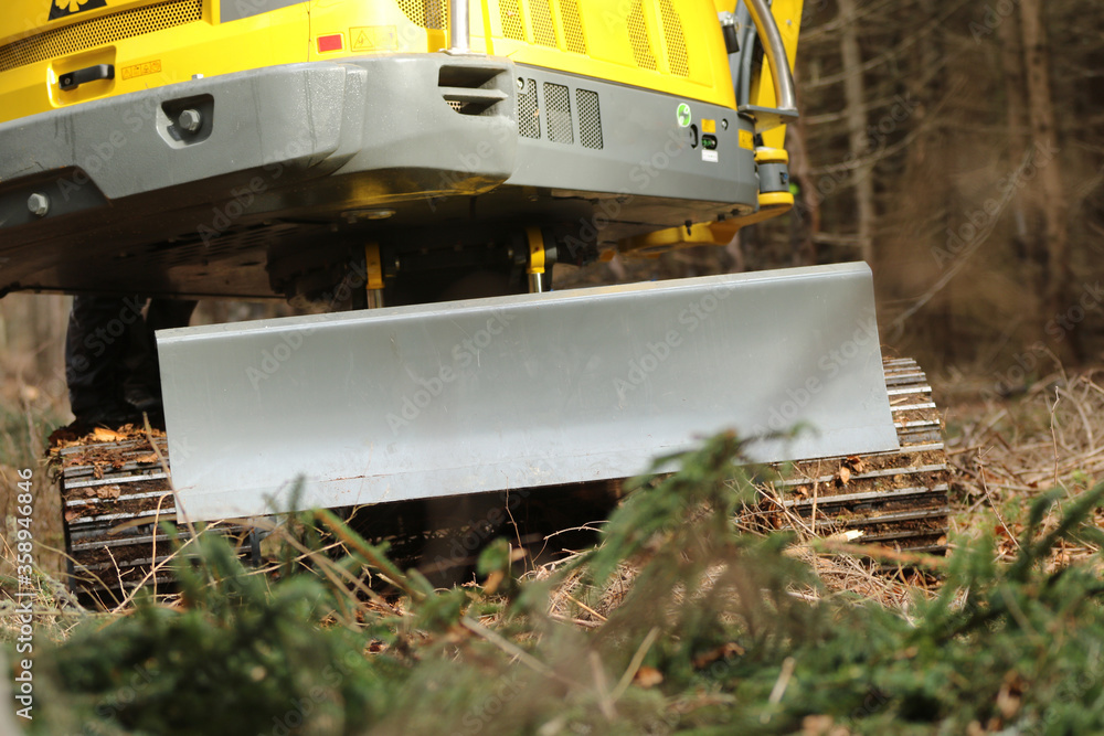 Close-up shot of forest harvester trolley with track share. Machine on excavator chassis.