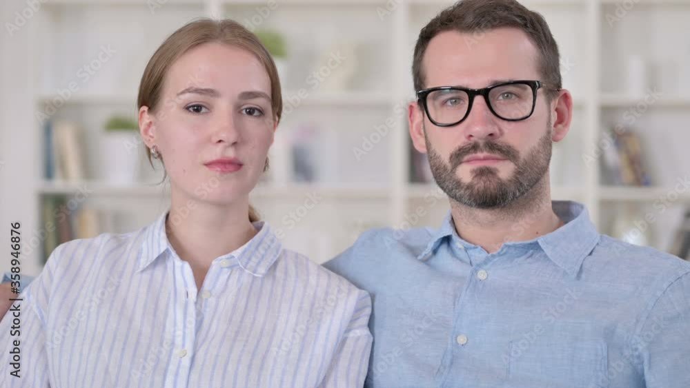 Portrait of Serious Young Couple Looking at the Camera Portrait of Serious Young Couple Looking at the Camera
