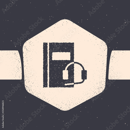 Grunge Audio book icon isolated on grey background. Book with headphones. Audio guide sign. Online learning concept. Monochrome vintage drawing. Vector Illustration.