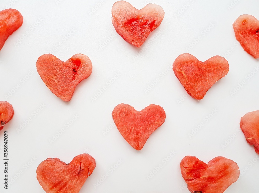 Bright juicy red watermelon in the form of a heart. Space for text.