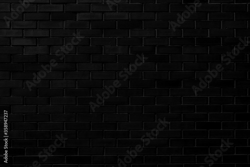 Black brick wall. Designer interior background. Abstract architectural surface.