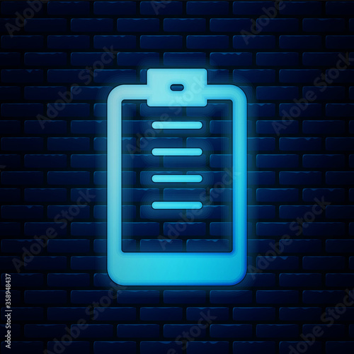 Glowing neon Clipboard with checklist icon isolated on brick wall background. Control list symbol. Survey poll or questionnaire feedback form. Vector.