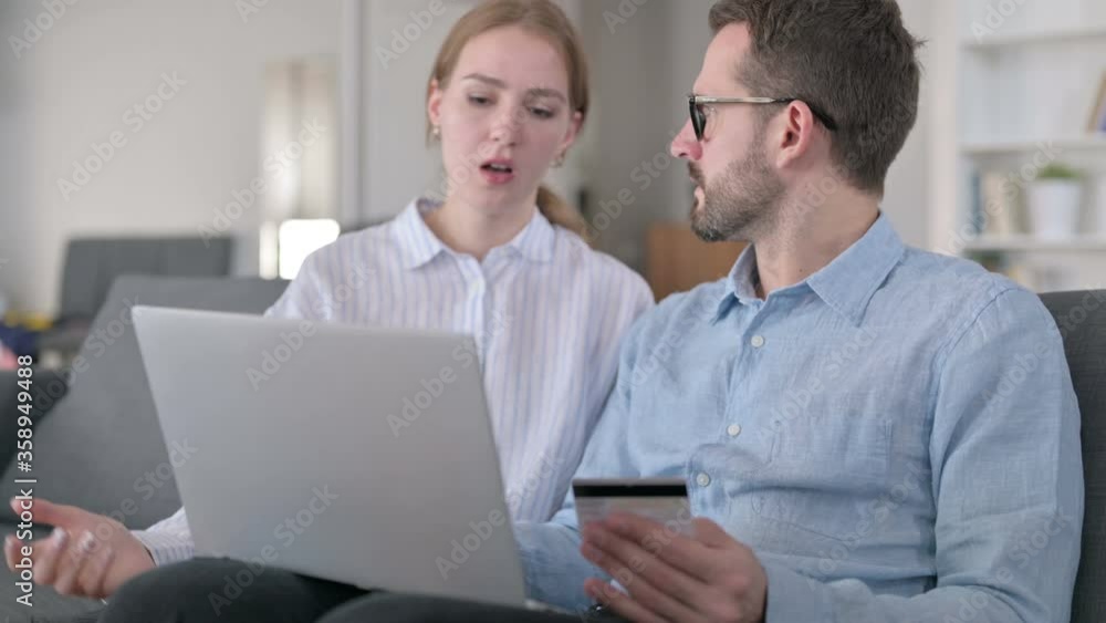 Young Couple having Online Payment Loss on Laptop at Home Young Couple having Online Payment Loss on Laptop at Home