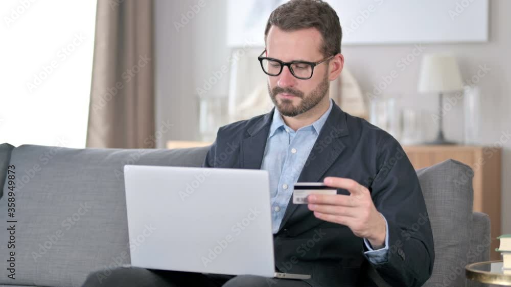 Successful Online Payment on Laptop by Young Man Successful Online Payment on Laptop by Young Man