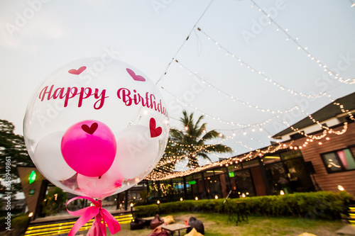 Happy birthday balloons are provided at the birthday party.