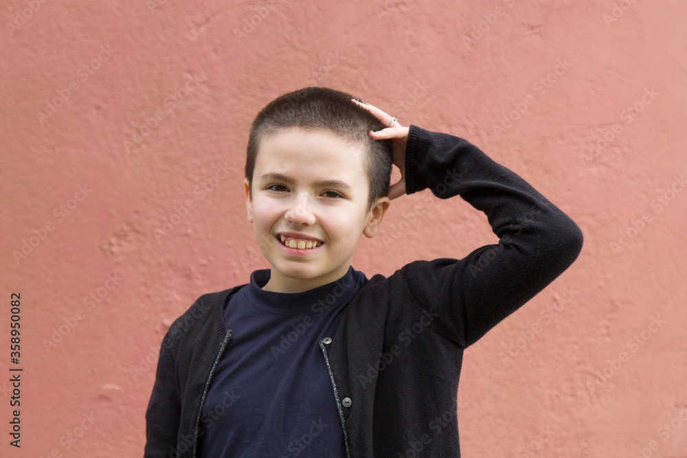 Teenager girl with short hair over pink wall laughing Teenager girl with short hair over pink wall laughing