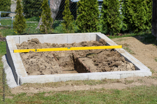 Preparation of foundations and internal sidewalk for the greenhouse.