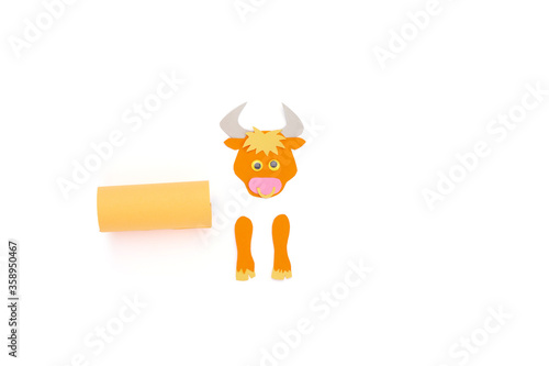 ox or bull toilet paper roll craft concept for kid and kindergarten, year of the ox, how to make bull, step by step instruction, tutorial, DIY, project step2, glue rectangular piece to tube, assambley photo