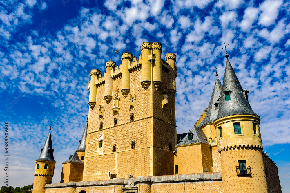 It's Alcazar of Segovia (Segovia Castle), a stone fortification, located in the old city of Segovia, Spain.