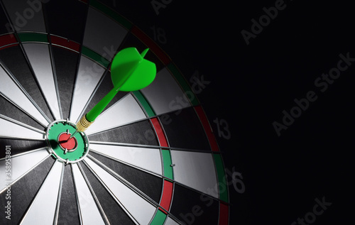 Dartboard with darts arrow hitting the center. Marketing concept.