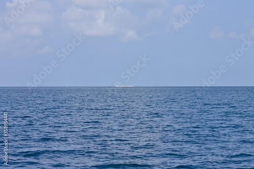 Distant view of a desert island in the Indian ocean (Ari Atoll, Maldives, Asia)