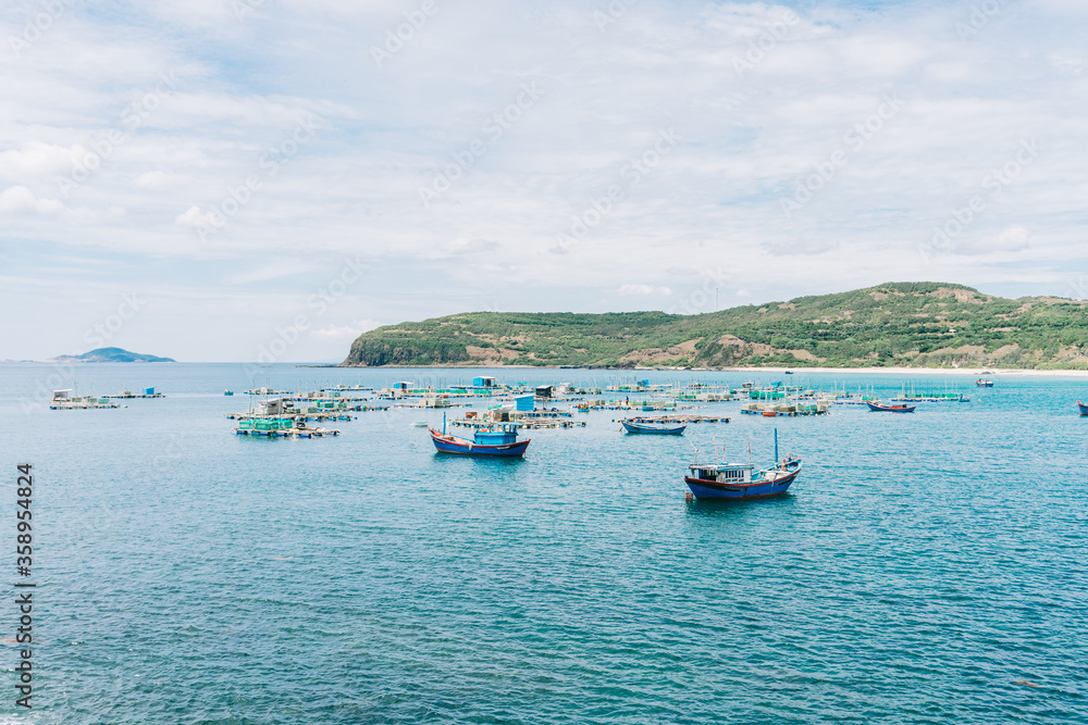 Quy Nhon harbor, Quy Nhon city, Binh Dinh province, Vietnam - 06/2020: Fishing boats docked at the port side
