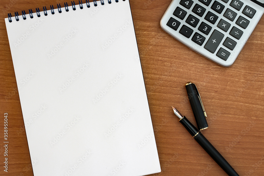 fountain pen with notepad on wooden table fountain pen with notepad on wooden table
