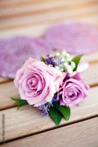 Boutonniere for groom made of purple roses