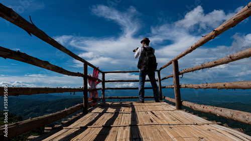 Εκτύπωση καμβά Young tourists taking pictures on the bridge to see the beautiful sky view, the