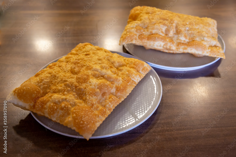 Chebureki or fried pie with meat on plate close up Chebureki or fried pie with meat on plate close up